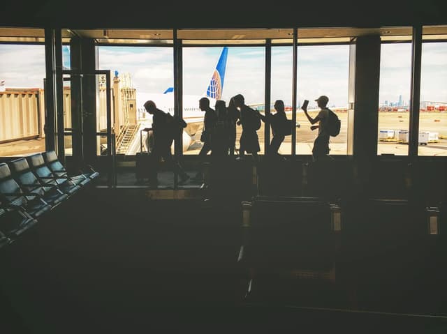Travelers at a departure gate with an aircraft ready to leave