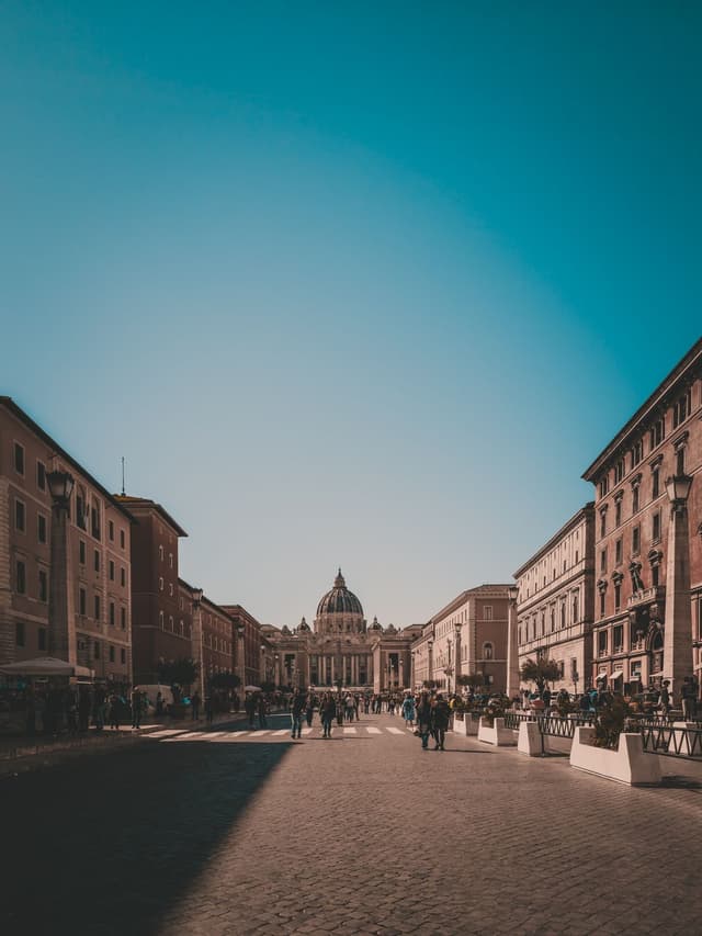 Travelers walking through Rome near Saint Peter's Basilica