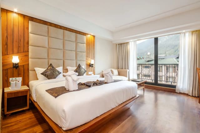Boutique hotel room with warm wood finishes and a mountain view