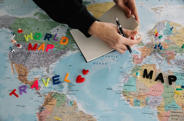 Hands organizing a route on a map